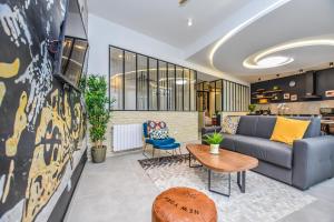 a living room with a couch and a table at CMG Place d'Italie/ Les Gobelins in Paris