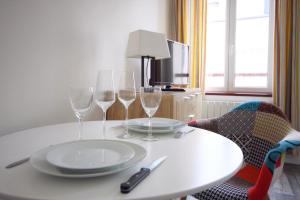 a white table with two wine glasses on it at " Le Léana Cardi " Fécamp Bord de mer in Fécamp