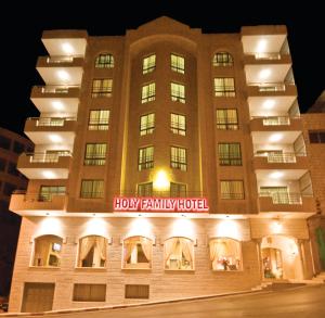 a building with a holly family hotel lit up at night at Holy Family Hotel in Bethlehem