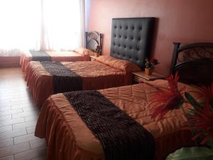 Кровать или кровати в номере Los Apus Mayaki