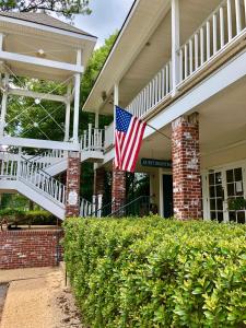 una bandera americana en el frente de una casa en The Lodge at The Bluffs, en Saint Francisville