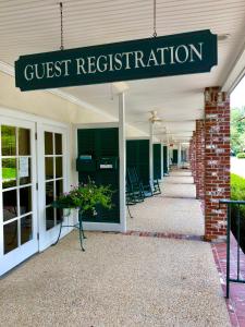 a building with a sign that reads guest registration at The Lodge at The Bluffs in Saint Francisville