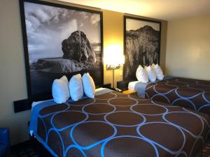 A bed or beds in a room at Super 8 by Wyndham Carson City Lake Tahoe