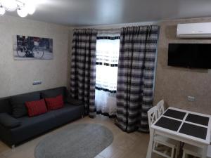 a living room with a couch and a table at Luxuri apartments in Chernihiv