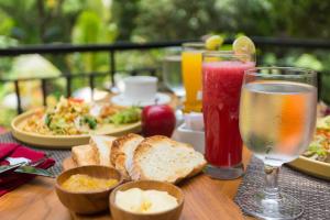 a table topped with plates of food and drinks at Puri Payogan Villa in Ubud