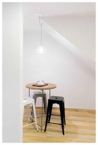 a table with two chairs and a stool in a room at Rent Nuñez 2830 in Buenos Aires