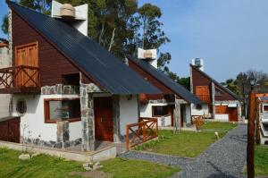 a house with a solar roof on top of it at Complejo de Cabañas lo de Otto , Los Acantilados , Mar del plata in Mar del Plata