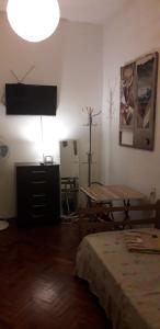 a room with a bed and a table and a television at Stone Wasi in Montevideo