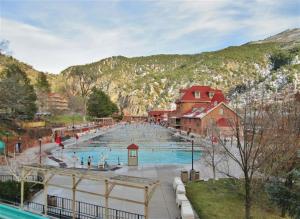a large swimming pool with people in it at Cozy Central Glenwood Springs Condo with 2 Decks! in Glenwood Springs