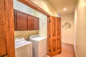 a small laundry room with a washer and dryer at Cozy Central Glenwood Springs Condo with 2 Decks! in Glenwood Springs