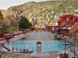a group of people in a swimming pool in a town at Cozy Central Glenwood Springs Condo with 2 Decks! in Glenwood Springs