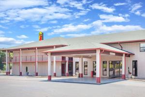 a building with a mcdonalds sign on top of it at Super 8 by Wyndham Malvern in Malvern