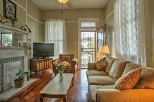 a living room with a couch and a fireplace at Classic New Orleans Home Near River, Zoo and Tram! in New Orleans