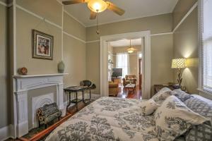 a living room with a bed and a fireplace at Classic New Orleans Home Near River, Zoo and Tram! in New Orleans