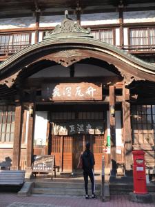 a person standing in front of a building at Ecol Beppu in Beppu