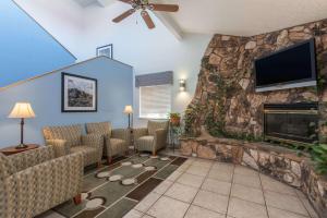 a living room with a fireplace and a flat screen tv at Days Inn by Wyndham Las Vegas in Las Vegas