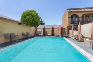 a swimming pool with chairs at Days Inn by Wyndham Bishop in Bishop