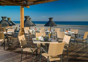 a restaurant on the beach with tables and chairs at Vidanta Puerto Peñasco in Puerto Peñasco