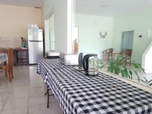 a kitchen with a table with a black and white checkered table cloth at Komodo Boutique Hotel in Labuan Bajo