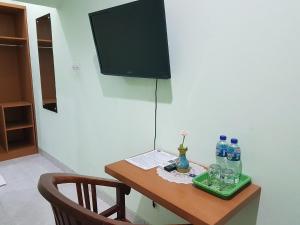 una mesa con ordenador portátil y botellas de agua. en Komodo Boutique Hotel, en Labuan Bajo