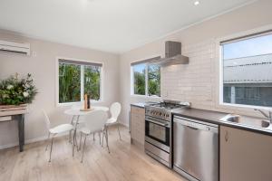 a kitchen with a sink and a table with chairs at Fifteen B - National Park Holiday Home in National Park