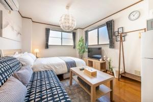 Postel nebo postele na pokoji v ubytování Uhome Ueno Apartment 4