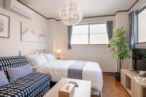 Postel nebo postele na pokoji v ubytování Uhome Ueno Apartment 4