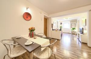 a dining room and living room with a table and chairs at Apartment City Center in Rijeka