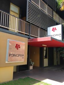 a building with a sign for a pomacana at Darwin Poinciana Inn in Darwin