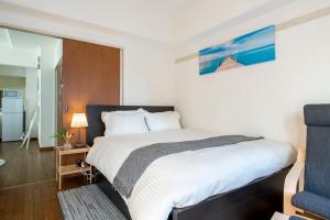 Postel nebo postele na pokoji v ubytování Uhome Akihabara Apartment 3