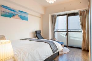 Postel nebo postele na pokoji v ubytování Uhome Akihabara Apartment 3