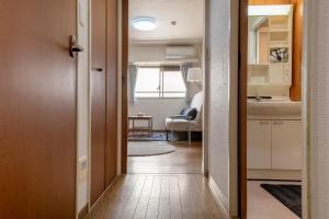 Postel nebo postele na pokoji v ubytování Uhome Akihabara Apartment 3