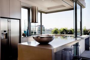 a kitchen with a stainless steel sink and a large window at Art Series - The Olsen in Melbourne