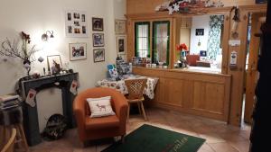 a living room with a table and a chair at Apart-Pension Oberreiter in Fusch an der Glocknerstraße