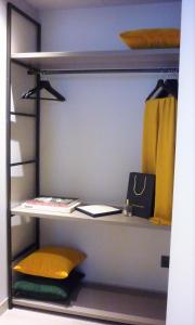 a closet with a shelf with a book at HOTEL TORRENT in L'Escala