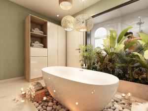a bathroom with a large white tub and plants at THE VILLA HIEU HY in Quy Nhon