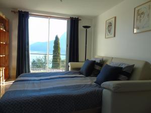 a bedroom with a bed and a large window at La Villa 05 in Chorges
