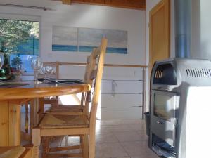 a dining room with a table and a stove at La Villa 05 in Chorges +30 photos