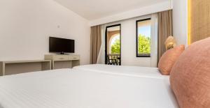 Posteľ alebo postele v izbe v ubytovaní Apartamentos Sinfony