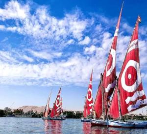 a group of sailboats on a body of water at White House Apartments in Luxor