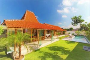 una imagen de una casa con techo naranja en Villa Daya, en Canggu