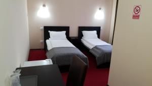 A bed or beds in a room at Motel Diamant