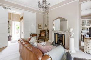 a living room with a couch and a fireplace at Beautiful Studio with private outside terrace in Bath