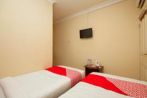 En eller flere senger på et rom på OYO 2045 Hotel 211