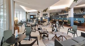 a restaurant with tables and chairs and a bar at Aminess Vival Maestral Hotel in Novigrad Istria