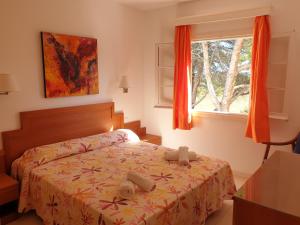 Un dormitorio con una cama con dos animales de peluche encima. en Apartamentos Piscis, en Cala Blanca 48 fotos más