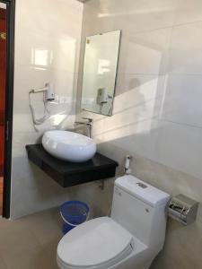 a bathroom with a white toilet and a sink at MAI VANG Hotel in Sapa +9 photos