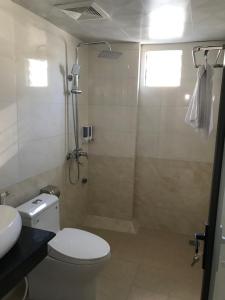 a bathroom with a shower and a toilet and a sink at MAI VANG Hotel in Sapa