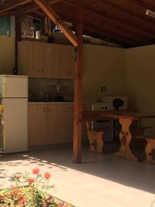 a kitchen with a wooden table and a refrigerator at Villa Maris in Obzor