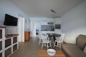 a living room with a couch and a table and chairs at Haus Luna in Schwangau